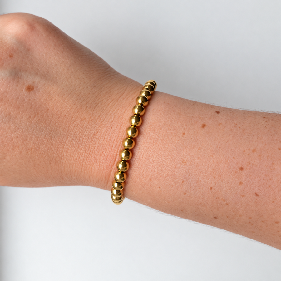 Armband met bolletjes – goudkleurig gedragen aan de pols