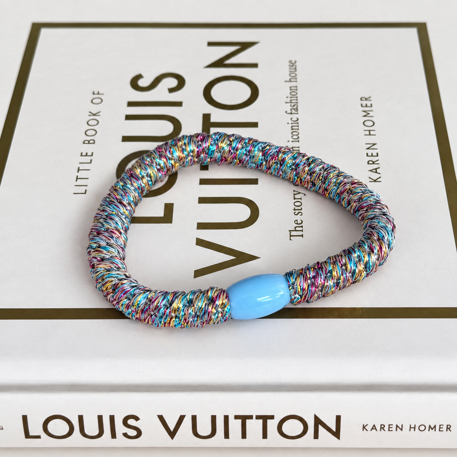 Glitterhaarelastiek – lichtblauw multicolor op boeken